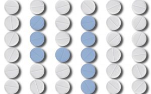 A bunch of pills are sitting in rows