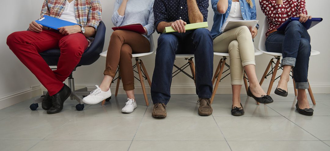 A group of people sitting on chairs in a room.