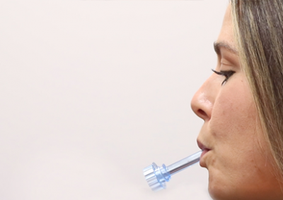 OralTox rapid oral fluid device photo. Donor holding the device in their mouth.